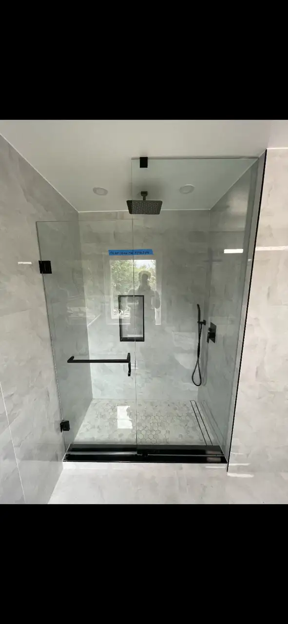 Luxuriously renovated modern bathroom with custom tile surround, new vanity and updated fixtures