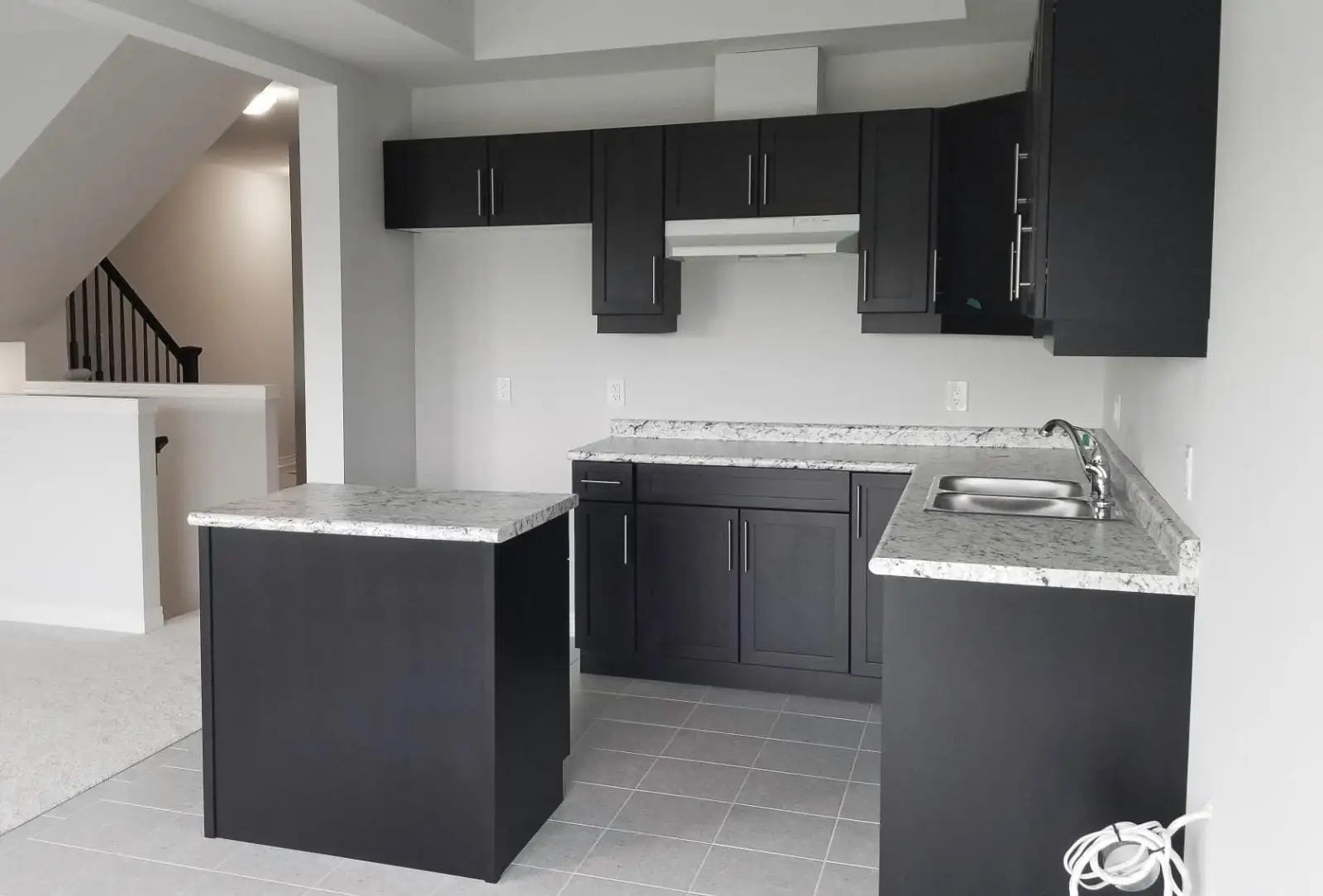 Modern kitchen remodel with updated cabinetry, quartz countertops and tile backsplash