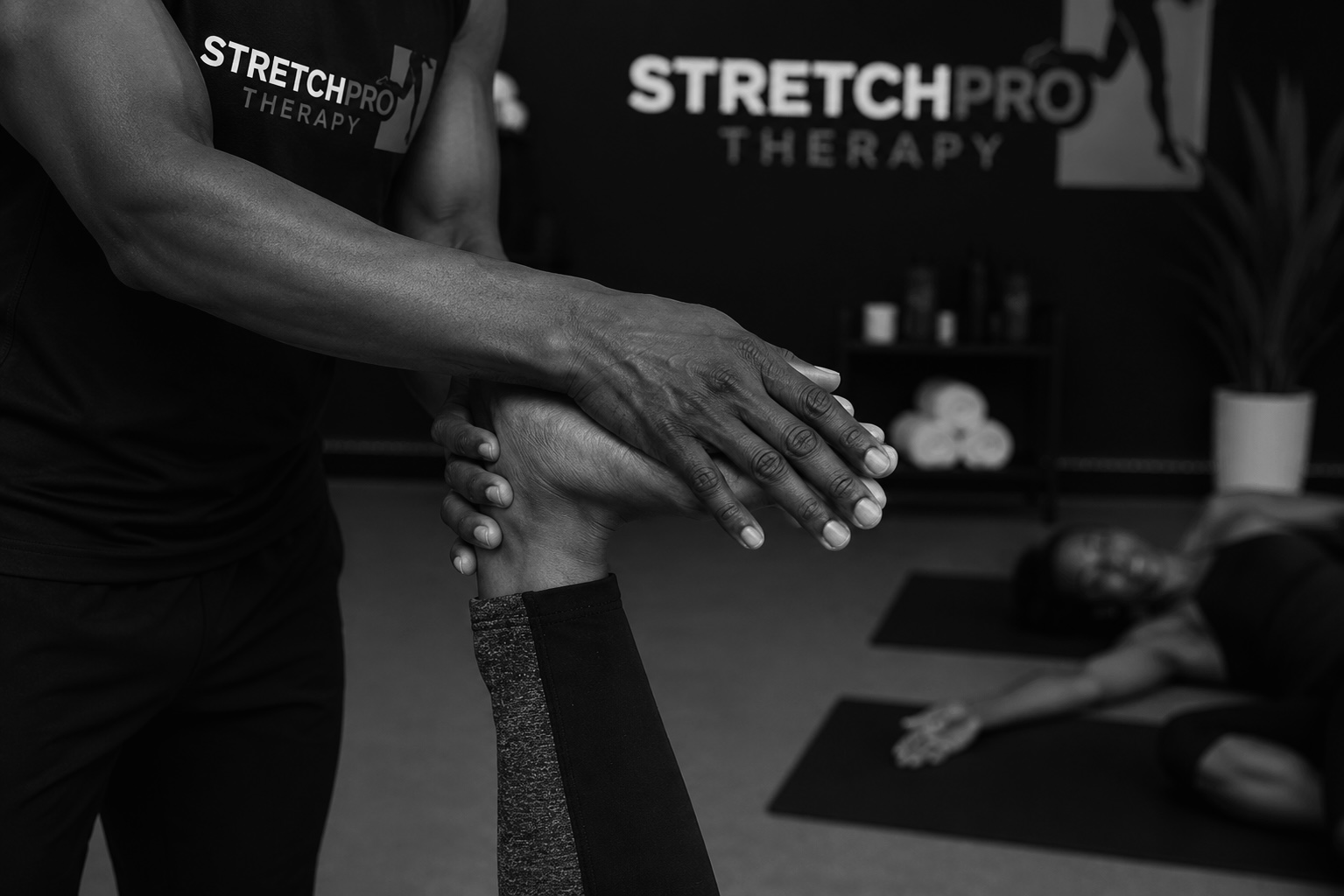Therapist assisting a client with stretching