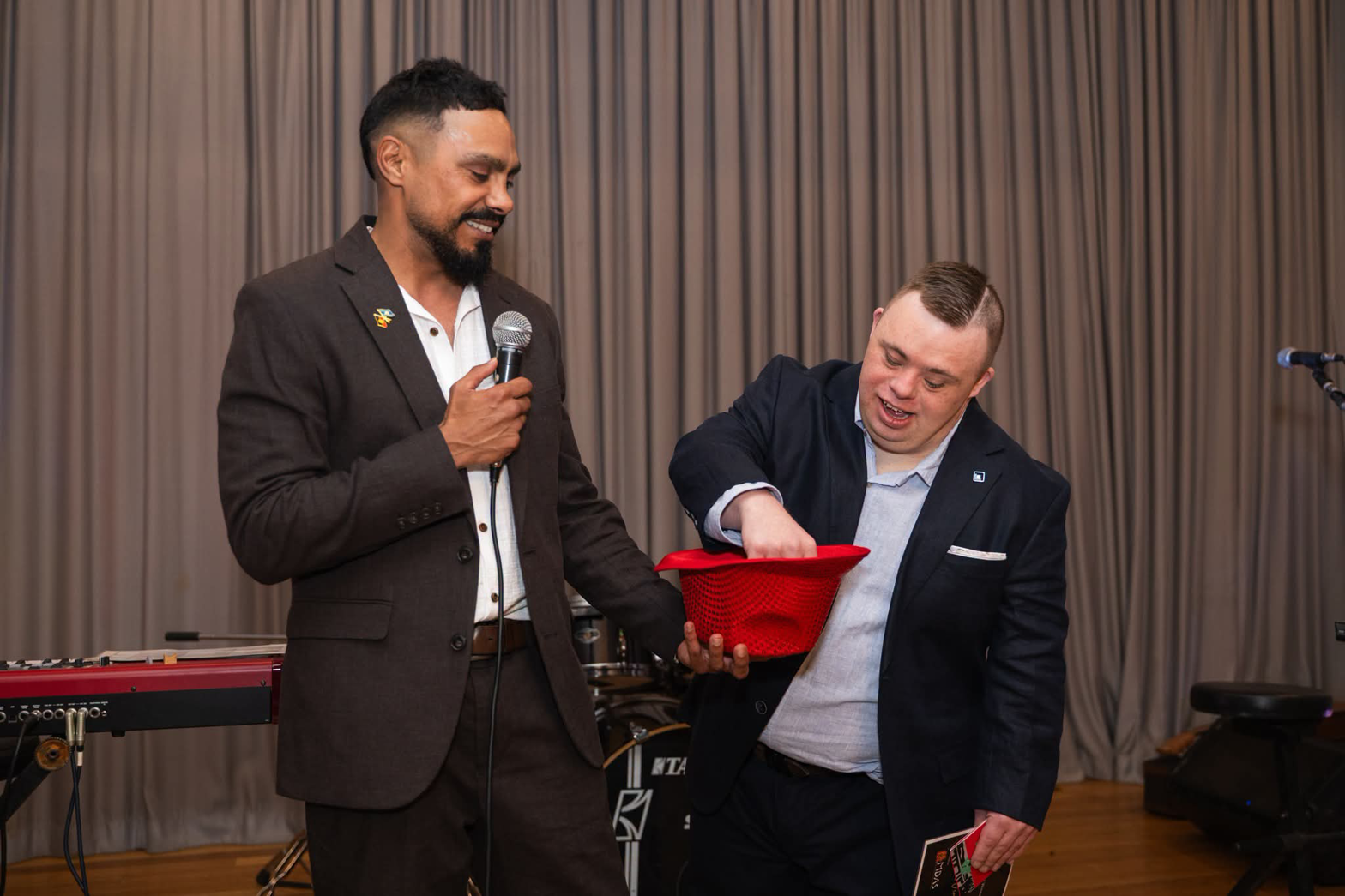 Brotherboy Bill on stage with a microphone during an MC appearance